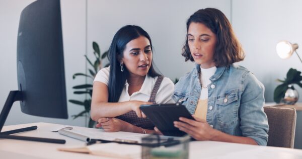 two women writing website content